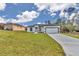 Exterior view of the home with a two-car garage and a well-maintained front yard at 2844 Sw 162Nd Street Rd, Ocala, FL 34473