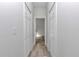 Hallway with white doors and wood-look flooring at 2844 Sw 162Nd Street Rd, Ocala, FL 34473