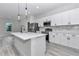 Modern kitchen featuring white cabinets, stainless steel appliances, quartz countertop, and a stylish kitchen island at 2844 Sw 162Nd Street Rd, Ocala, FL 34473