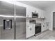 Close up of a modern kitchen with stainless steel refrigerator, white cabinets, and stainless steel oven at 2844 Sw 162Nd Street Rd, Ocala, FL 34473