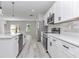 Well-lit kitchen featuring stainless steel appliances, white cabinets, quartz countertops, and an open-concept design at 2844 Sw 162Nd Street Rd, Ocala, FL 34473