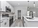 Bright kitchen with stainless steel appliances, white cabinets, quartz countertops, and a stylish faucet over the island sink at 2844 Sw 162Nd Street Rd, Ocala, FL 34473