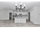 Open living space featuring a modern chandelier, recessed lighting, white walls, and plank flooring throughout the home at 2844 Sw 162Nd Street Rd, Ocala, FL 34473