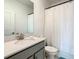 Bathroom features a vanity with a white countertop, a brushed nickel faucet, and a shower at 2908 Protagonist St, Kissimmee, FL 34746