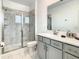 Modern bathroom features a marble tiled shower and a gray vanity with white countertop at 2908 Protagonist St, Kissimmee, FL 34746