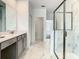 Modern bathroom with a glass shower, dual sink vanity, and elegant marble flooring at 2908 Protagonist St, Kissimmee, FL 34746