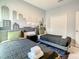 Bedroom with twin beds, gray and black bedding, and skyline wall art at 2908 Protagonist St, Kissimmee, FL 34746