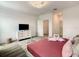 Cozy bedroom featuring a comfortable bed, modern dresser and TV for relaxing evenings at 2908 Protagonist St, Kissimmee, FL 34746