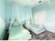Charming bedroom features twin beds with draped canopies, a chandelier, and closet at 2908 Protagonist St, Kissimmee, FL 34746