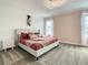 Inviting bedroom with a plush, tufted headboard bed and soft pink accents for relaxation at 2908 Protagonist St, Kissimmee, FL 34746