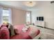 Bright bedroom featuring two windows and a comfy bed, alongside a sleek TV and dresser at 2908 Protagonist St, Kissimmee, FL 34746