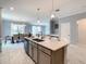 Open-concept kitchen with large island, stainless steel appliances, and seamless transition to the adjacent dining area at 2908 Protagonist St, Kissimmee, FL 34746