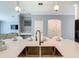 Bright and airy kitchen with stainless steel sink, quartz countertops, and open access to the living area at 2908 Protagonist St, Kissimmee, FL 34746