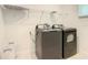 Bright laundry room has a gray washer/dryer set with a wire rack above at 2908 Protagonist St, Kissimmee, FL 34746