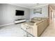 Comfortable living room with plush sectional sofa, marble floors, modern entertainment center, and stylish decor at 2908 Protagonist St, Kissimmee, FL 34746