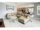 Open-concept living room with a large sectional sofa, marble floors, and seamless access to the kitchen and dining area at 2908 Protagonist St, Kissimmee, FL 34746
