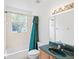 Bathroom featuring a tub, shower and a green vanity with matching accents at 2935 Willow Bay Ter, Casselberry, FL 32707