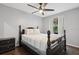 Bedroom with a queen size bed, ceiling fan, wood flooring, and a window at 3151 Britannia Blvd # A, Kissimmee, FL 34747