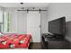 Nicely decorated bedroom featuring barn door closet and a large window at 3151 Britannia Blvd # A, Kissimmee, FL 34747