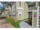 Close up of condo building with light green siding, white trim, and a walkway to the entrance at 3151 Britannia Blvd # A, Kissimmee, FL 34747