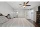 Comfortable main bedroom featuring a modern ceiling fan, barn door, and ensuite bathroom at 3151 Britannia Blvd # A, Kissimmee, FL 34747