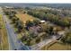 Aerial view of the property showing the home and surrounding landscape, including mature trees at 37224 Apiary Rd, Grand Island, FL 32735