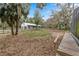 Picturesque property with wooden pathway leading to a barn at 37224 Apiary Rd, Grand Island, FL 32735