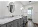 Bathroom with dual sinks and marble countertops on gray vanities, offering a blend of style and functionality at 37224 Apiary Rd, Grand Island, FL 32735