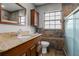 This bathroom features granite counters and tiled shower walls at 37224 Apiary Rd, Grand Island, FL 32735