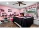 This bedroom is adorned in pink tones and filled with decorative items at 37224 Apiary Rd, Grand Island, FL 32735