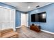 This bedroom features blue walls, wood flooring, and white trim and doors at 37224 Apiary Rd, Grand Island, FL 32735