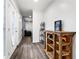 Bright entryway with modern wood-look floors and rustic wood shelving at 37224 Apiary Rd, Grand Island, FL 32735