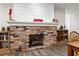 Rustic brick fireplace with built-in shelving, a white mantel, and wood-look flooring at 37224 Apiary Rd, Grand Island, FL 32735