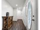 Inviting hallway with wood-look flooring and a decorative glass front door, complemented by a rustic console table at 37224 Apiary Rd, Grand Island, FL 32735