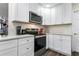 Modern kitchen featuring sleek stainless steel appliances and crisp white cabinetry for a clean and contemporary design at 37224 Apiary Rd, Grand Island, FL 32735