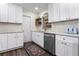 Charming kitchen with white cabinetry, stainless steel appliances, and a modern rug that provides a cozy atmosphere at 37224 Apiary Rd, Grand Island, FL 32735