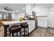 Bright kitchen featuring white cabinets, stainless steel appliances, and a breakfast bar with stools at 37224 Apiary Rd, Grand Island, FL 32735