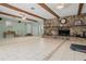 A large living area with a stone fireplace and beamed ceilings at 37224 Apiary Rd, Grand Island, FL 32735