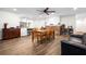 Cozy open living and dining space with a brick fireplace and wood-look tile floors at 37224 Apiary Rd, Grand Island, FL 32735