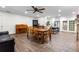 Open-concept living and dining area with wood-look tile, adjacent kitchen, and comfortable seating for entertaining at 37224 Apiary Rd, Grand Island, FL 32735