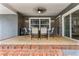 Covered patio features neutral colored walls, a ceiling fan, and a dining table with seating for six at 37224 Apiary Rd, Grand Island, FL 32735