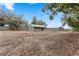 Wide angle of the grounds shows multiple barns, paddocks and fenced areas at 37224 Apiary Rd, Grand Island, FL 32735