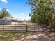 Entry to property featuring fenced pastures, barn, and tree-lined driveway on a sunny day at 37224 Apiary Rd, Grand Island, FL 32735