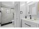 Bright bathroom with a walk-in shower, white vanity, and stylish fixtures at 4100 Cannon Ct, Kissimmee, FL 34746