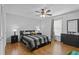 Bedroom features wood floors, a dark bed frame, and natural light from the window, creating a comfortable and inviting atmosphere at 4100 Cannon Ct, Kissimmee, FL 34746