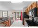Bright kitchen featuring wood cabinets, black appliances, and a breakfast bar, providing ample space for cooking and entertaining at 4100 Cannon Ct, Kissimmee, FL 34746