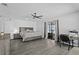 Bright main bedroom featuring wood-look floors, neutral walls, ceiling fan, and sliding glass doors to the backyard at 4100 Cannon Ct, Kissimmee, FL 34746