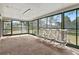 Enclosed sunroom with carpet, screens, and several chairs offering backyard views at 4100 Cannon Ct, Kissimmee, FL 34746