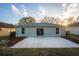 Back of house featuring a concrete patio and slider to backyard at 4135 Iveyglen Ave, Orlando, FL 32826