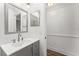 Bright bathroom with a gray vanity, modern fixtures, and a large mirror at 4135 Iveyglen Ave, Orlando, FL 32826